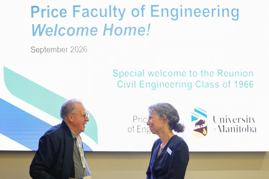 Dean Friesen and Civil Engineering Class '66 member conversing in front of welcome screen