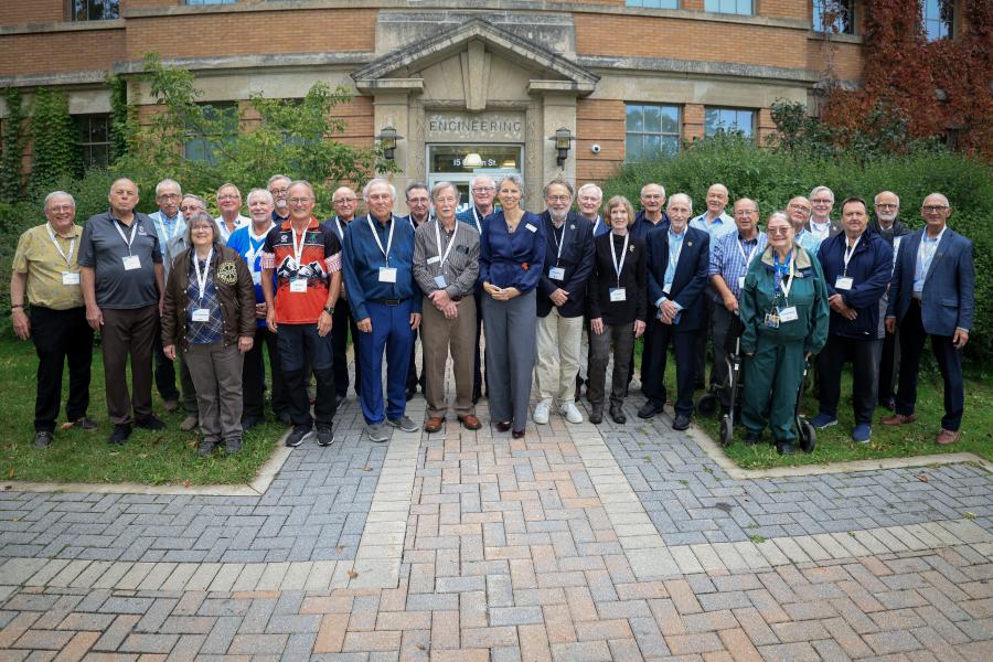 Classmates from Engineering Class of 1975 in front of exterior of  Engineering Building
