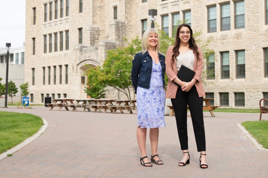 Career mentor Linda Churchill stands with an international student outdoors in front of the Buller Biological building. 