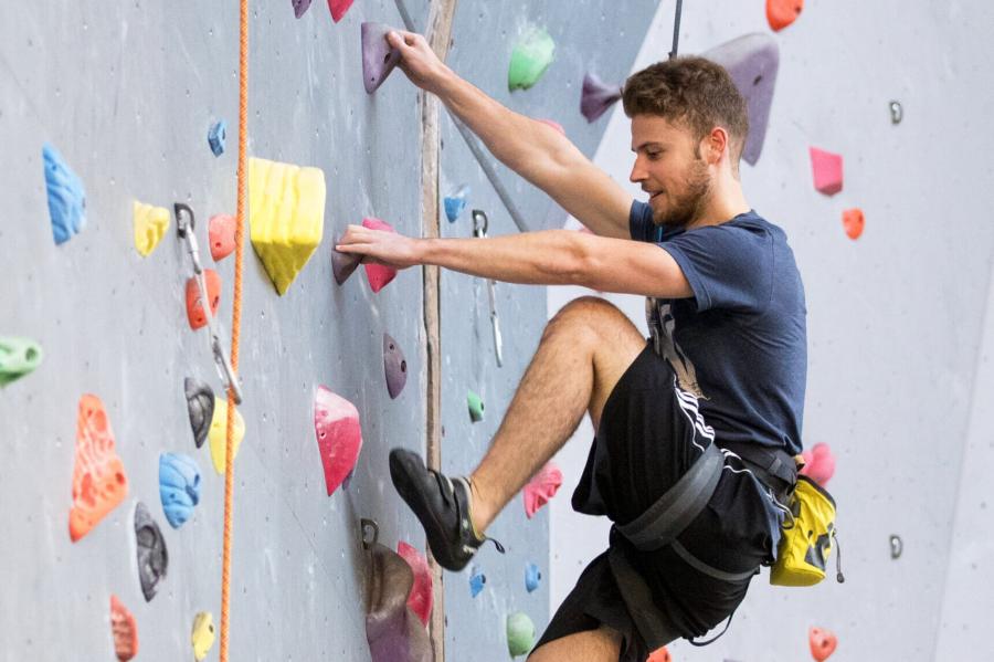 A man expertly scales the Active Living Centre climbing wall.