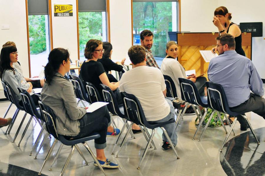 A classroom of people engaging in a conversation with each other.