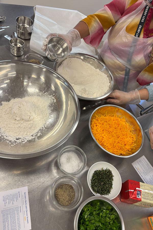 Ingredients for savoury herb and cheese scones in various bowls