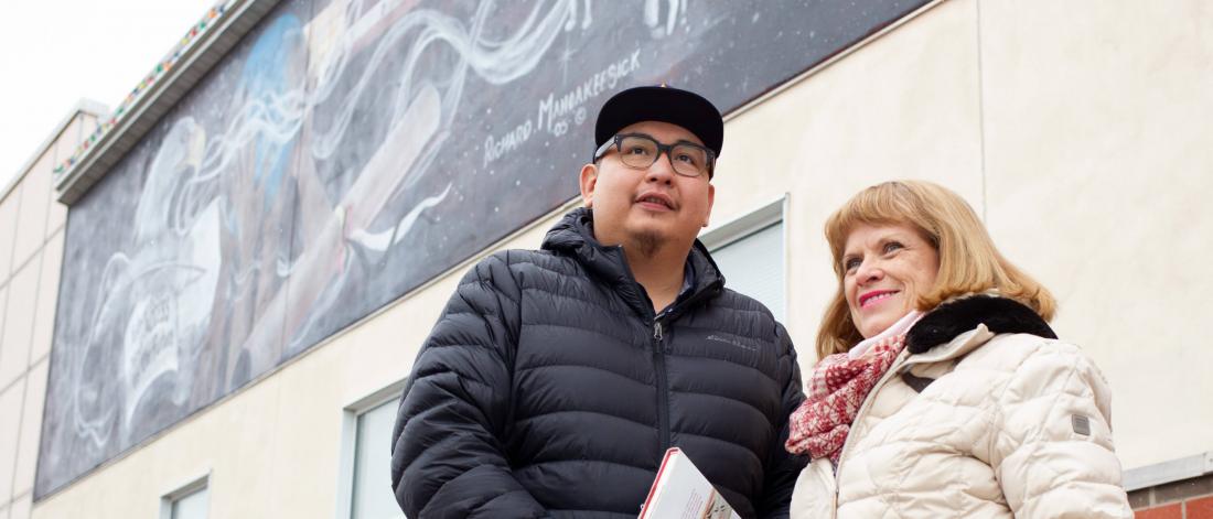 Undergraduate social work student Henry McKay stands in front of a building with his advisor.