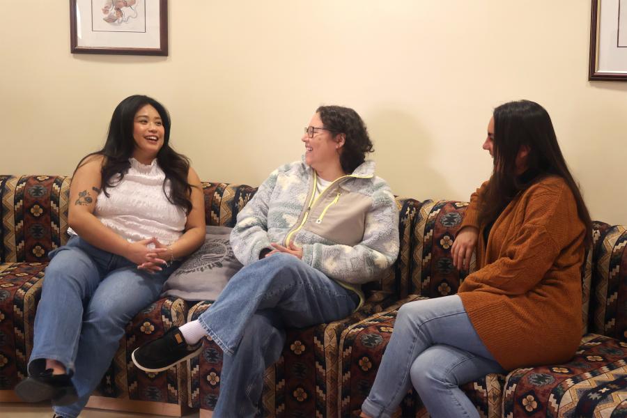 PhD doctoral students talking in round room