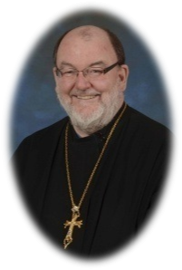 St. Andrew's College Dean The Rt. Rev. Mitred Archpriest Dr. Roman Bozyk in oval frame.