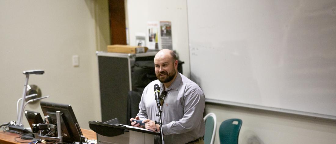 Photo of Ryan Turnbull speaking at a podium at the Wilmot Lecture Series