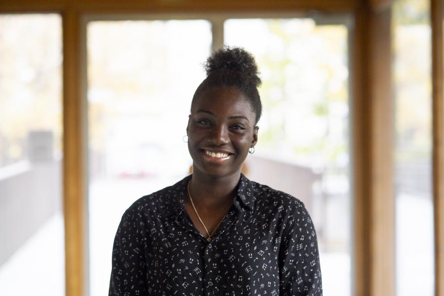 A student smiling for her portrait