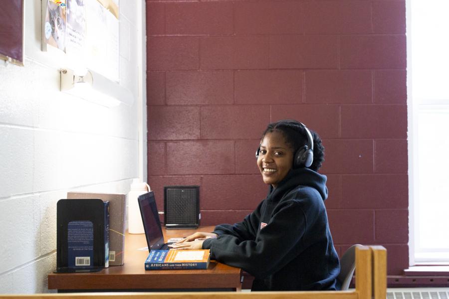 Tawana Matizanadzo sitting at her desk in her room