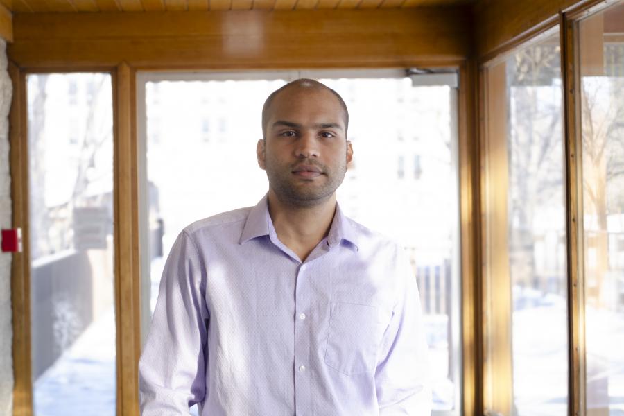Man standing in front of windows