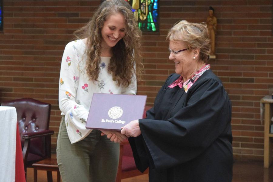 Student receives award from a Faculty member at St. Paul's College