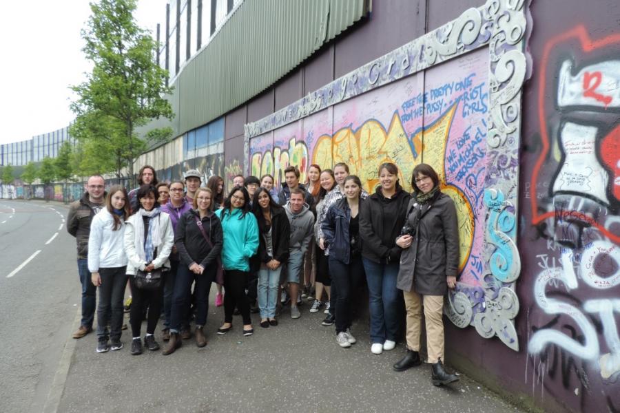 students in front of graffiti wall in ireland