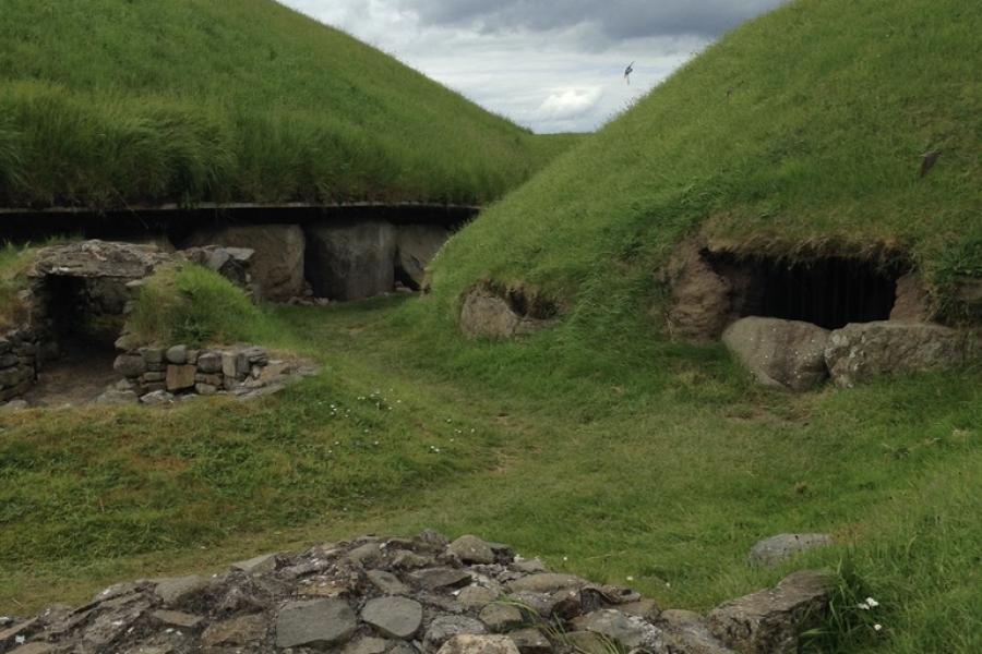 green hills with entry ways to tombs in ireland