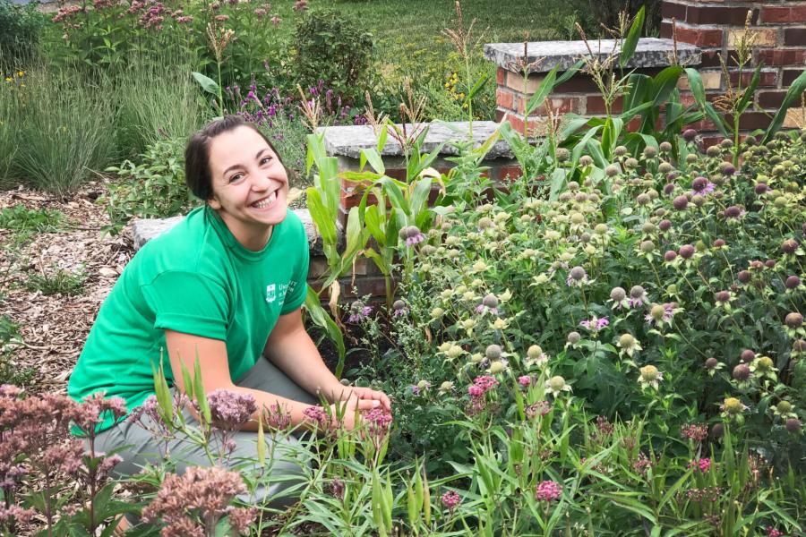 A sustainability ambassador works in the permaculture garden.