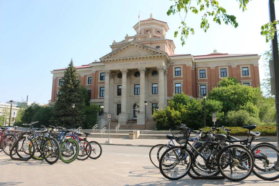 The Fort Garry campus Administration Building with two rows of bicycles in front of it.