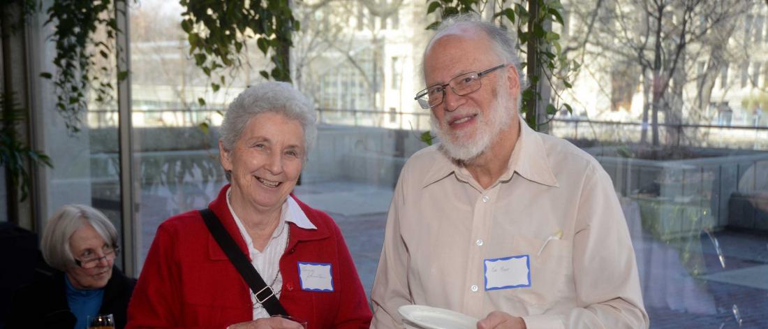 Two members of the retirees association, a woman and a man, smiling.