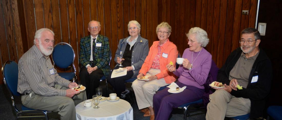 Six retirees association members chatting at the President's Reception.