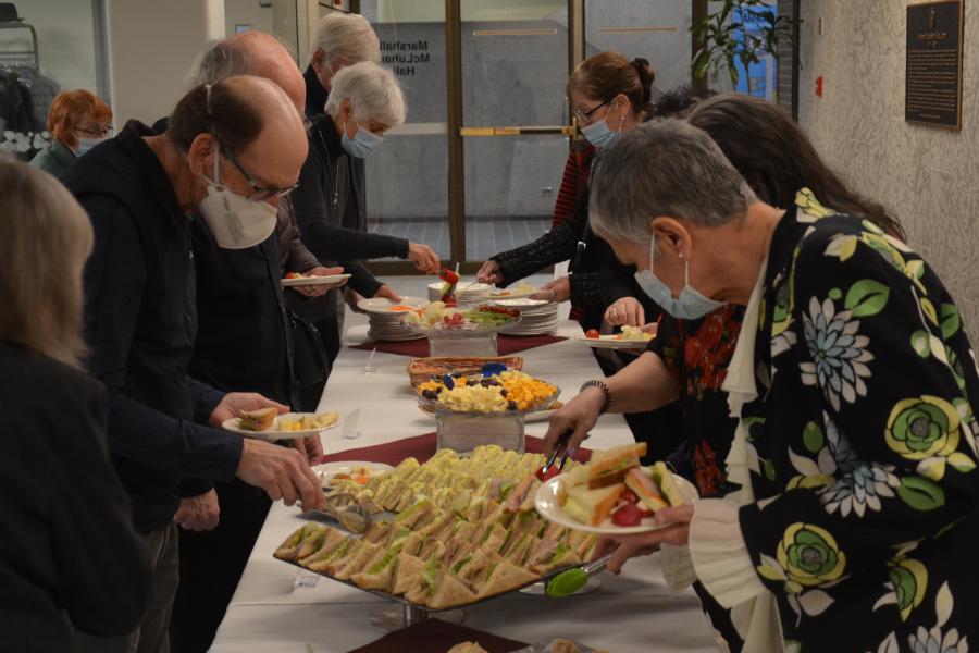 line-of-people-beside-a-food-table