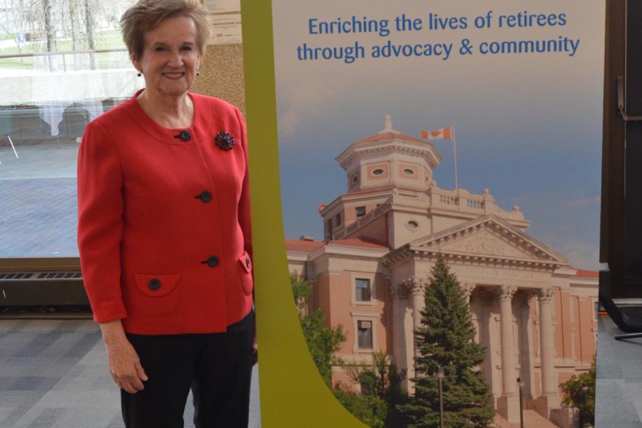 Janet Sealy with UMRA banner