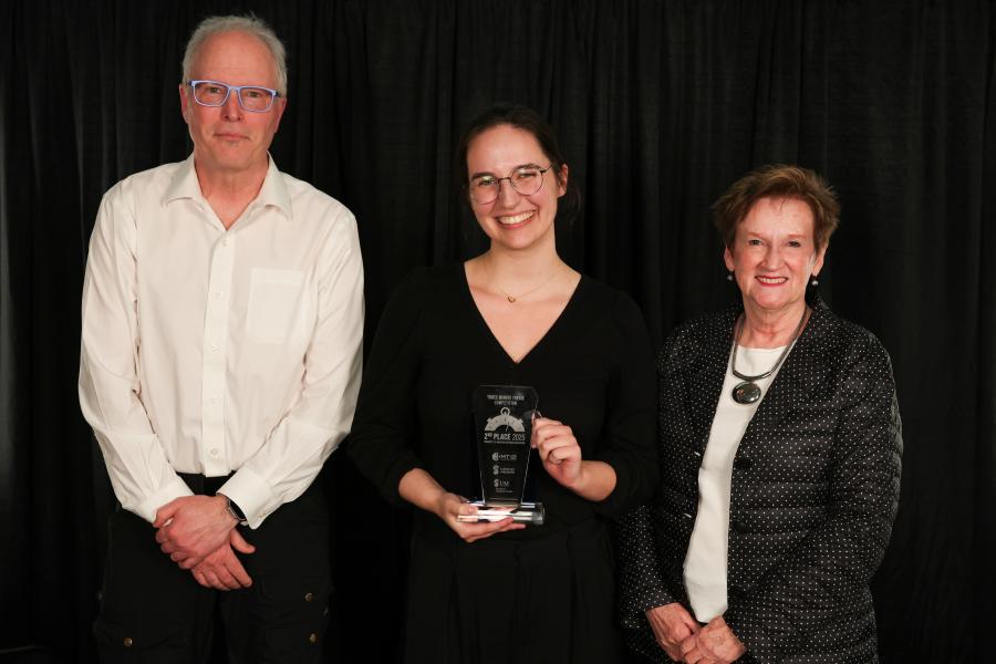 UMRA man and women presenting award to grad student