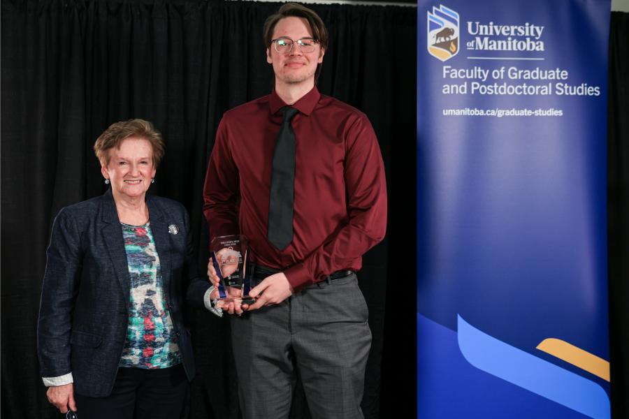 a man receiving an award from a woman