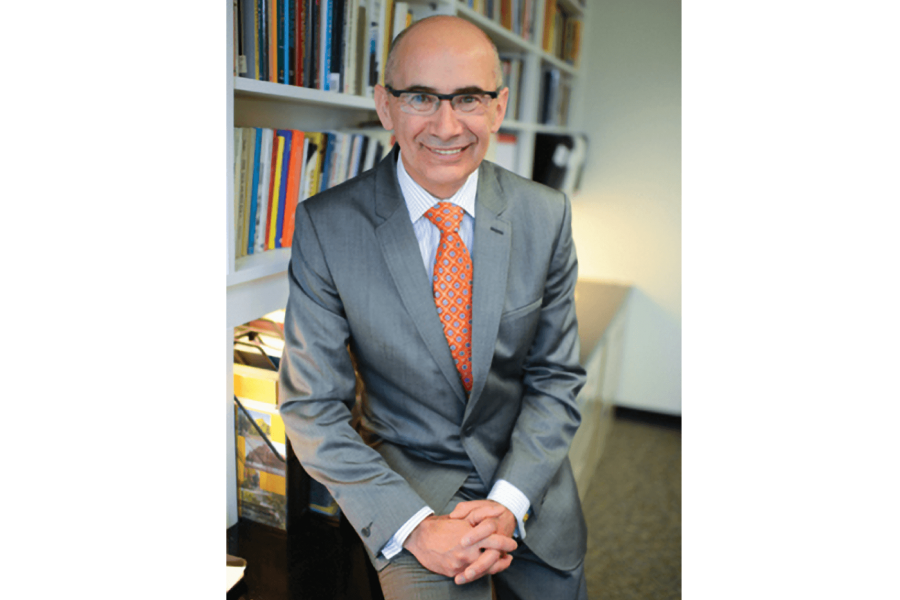 Acting provost Jeffrey Taylor, a bald man with glasses wearing a grey suit with an orange tie.